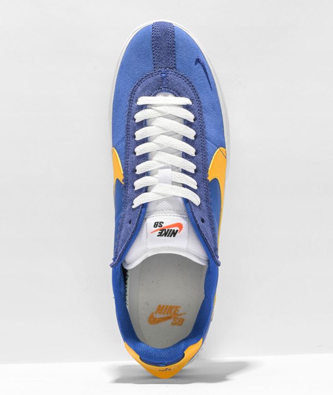 blue nike shoes with gold swoosh